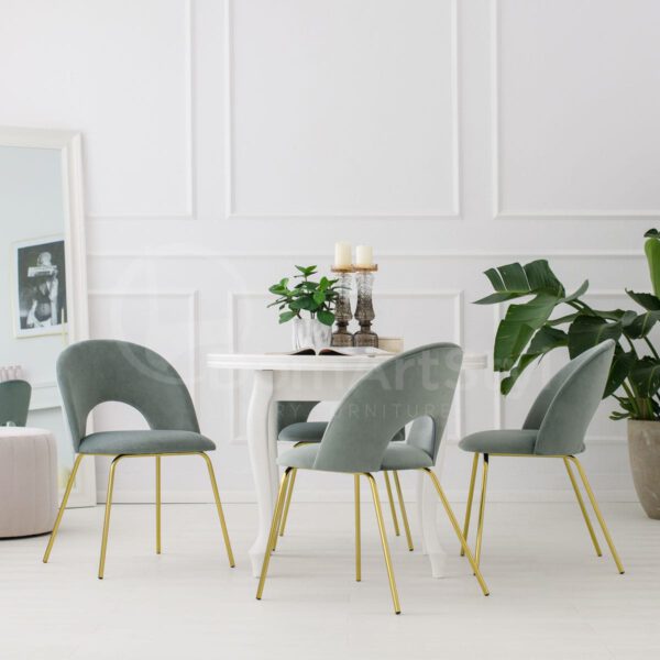 Gray velor chairs on gold legs for the Abisso Ideal Gold dining room